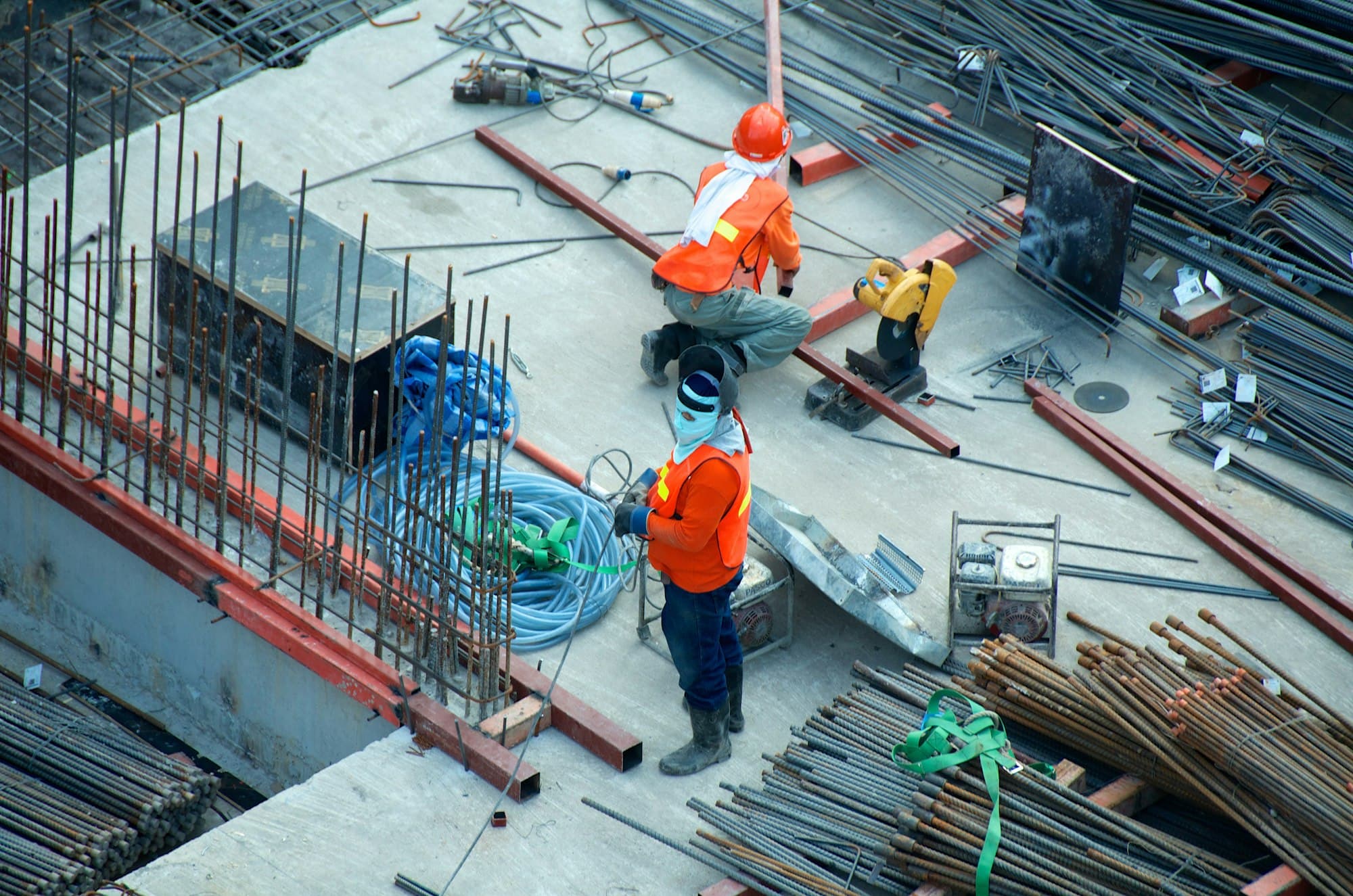 Construction workers on a building site — addressing structural repairs and maintenance common in strata schemes