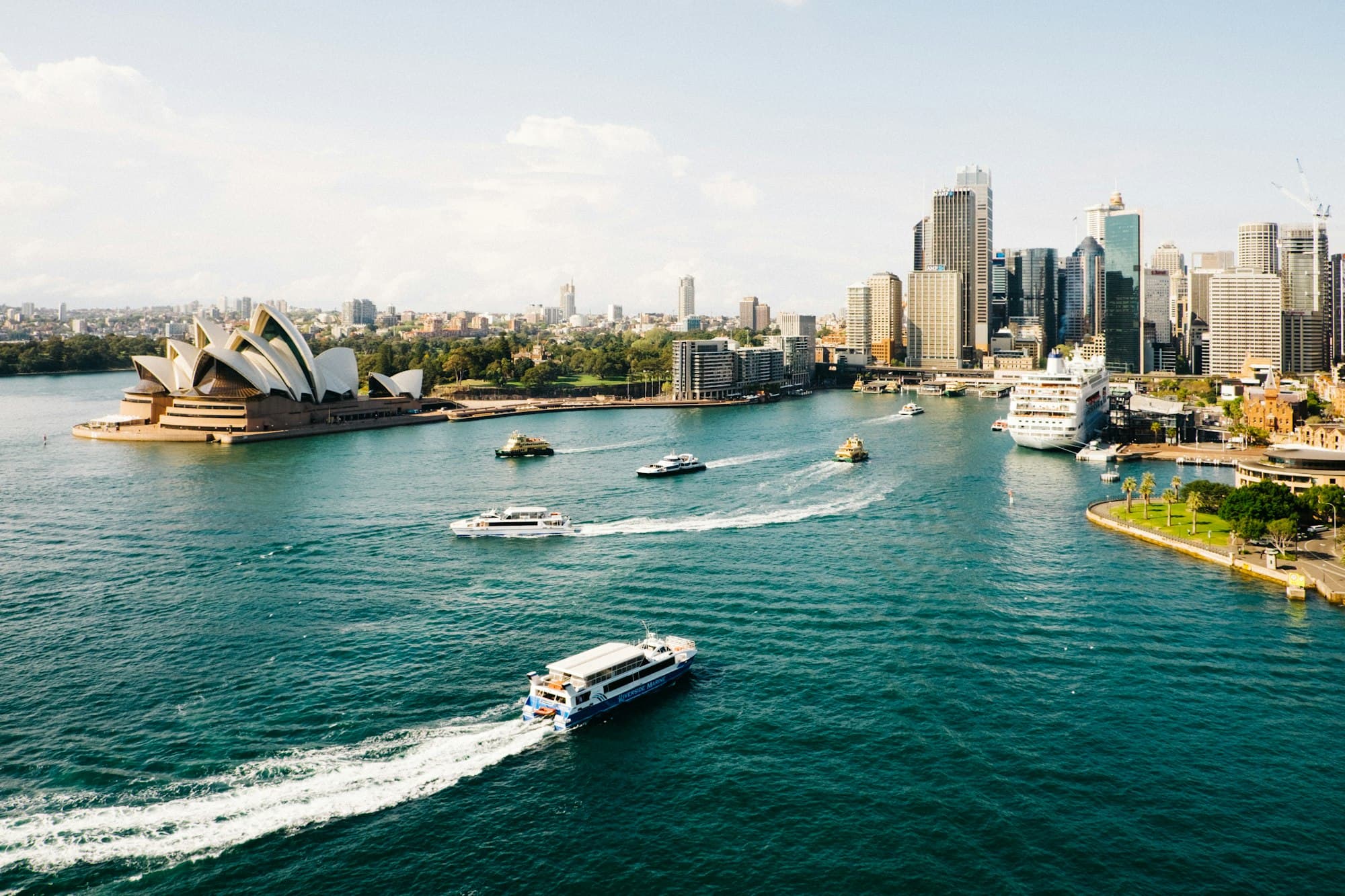 Aerial view of Sydney Harbour with the Opera House and city skyline — the heart of apartment living in NSW